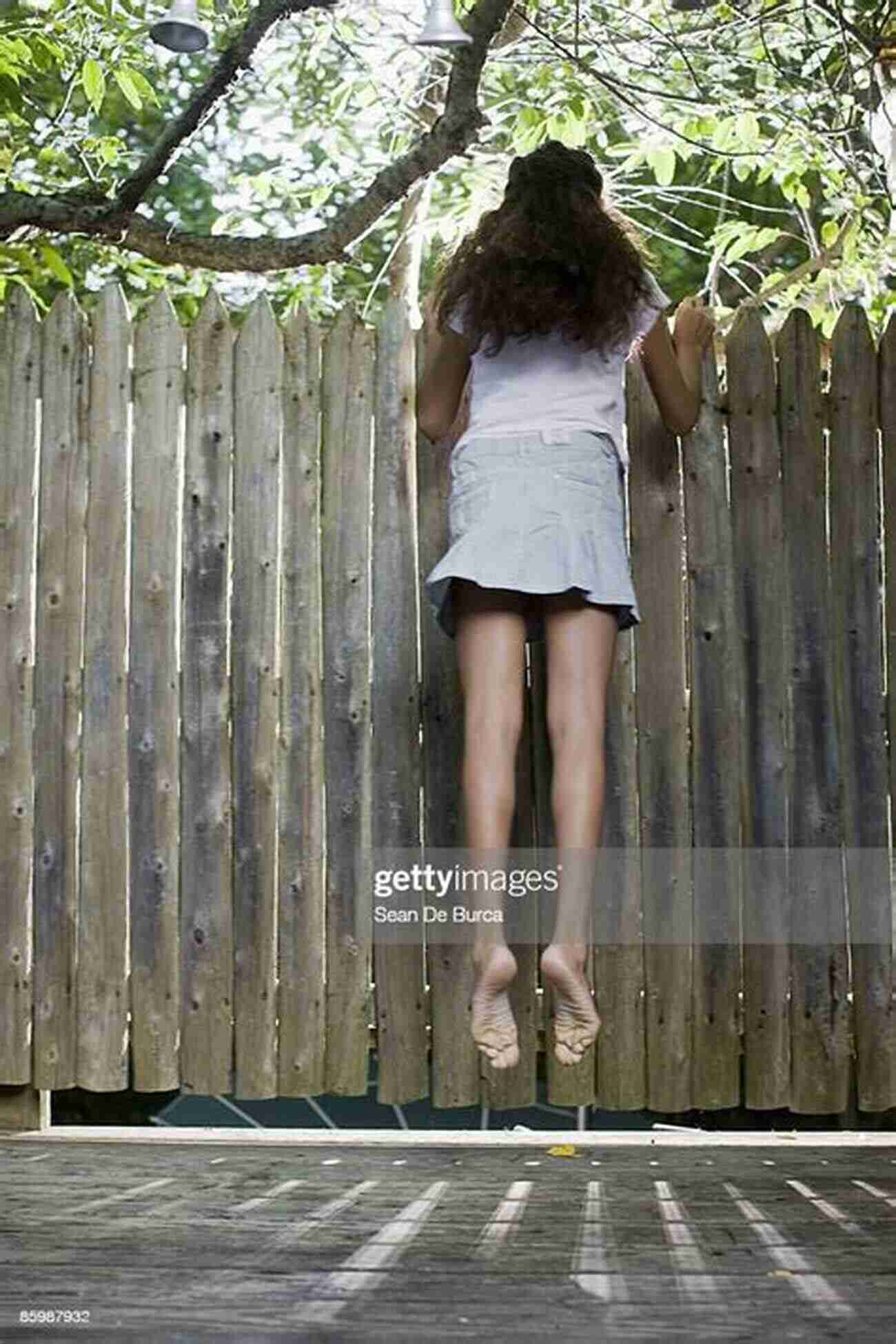 A Young Girl Peeking Through A Wooden Fence, Longing For Freedom The Girl Who Lived Behind The Fence: A Practical Guide Non Fiction Story For Teens And Young Adults