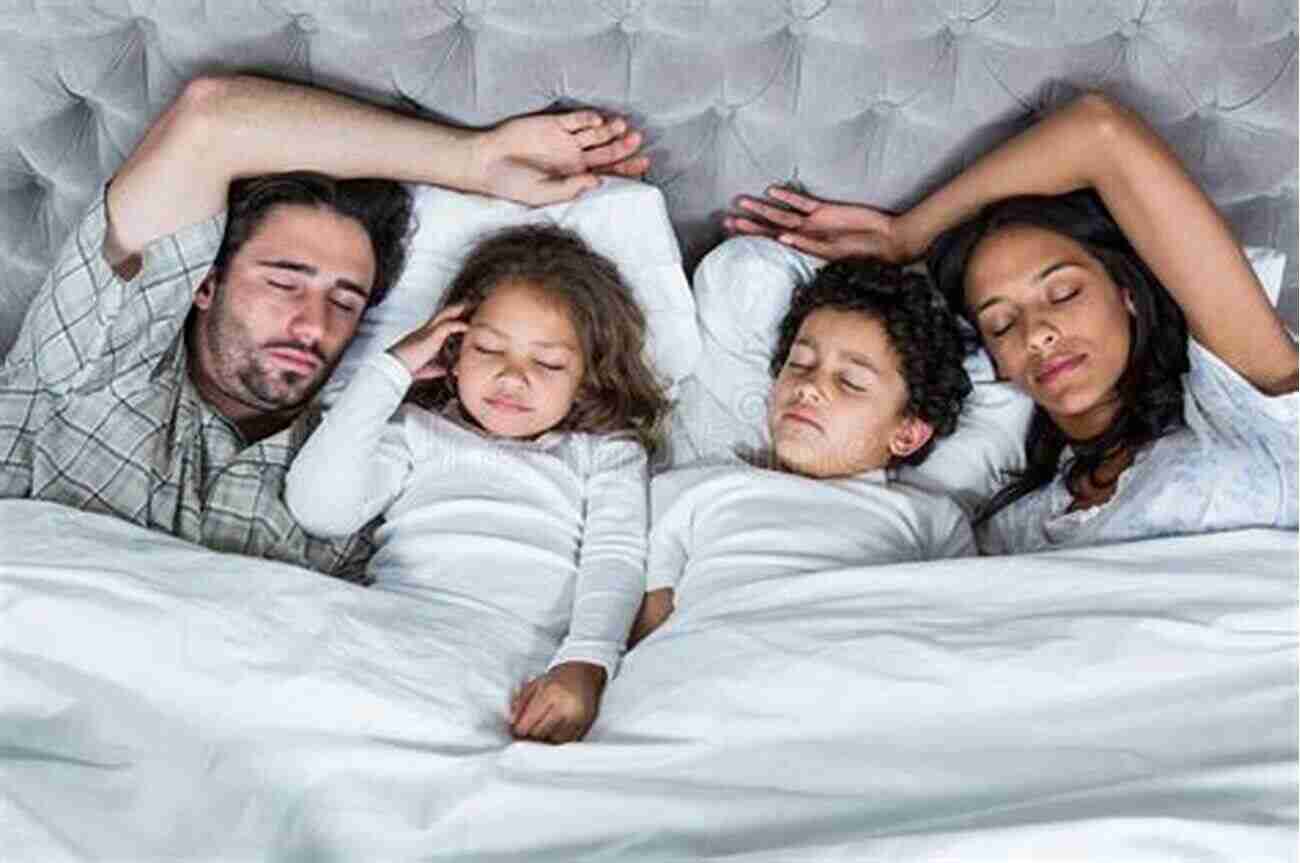 Happy Family Sleeping Together Three In A Bed: The Benefits Of Sleeping With Your Baby