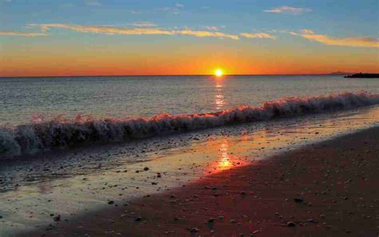 Mesmerizing Sunset Over The Calm Ocean Waves The Beauty Of The Moment